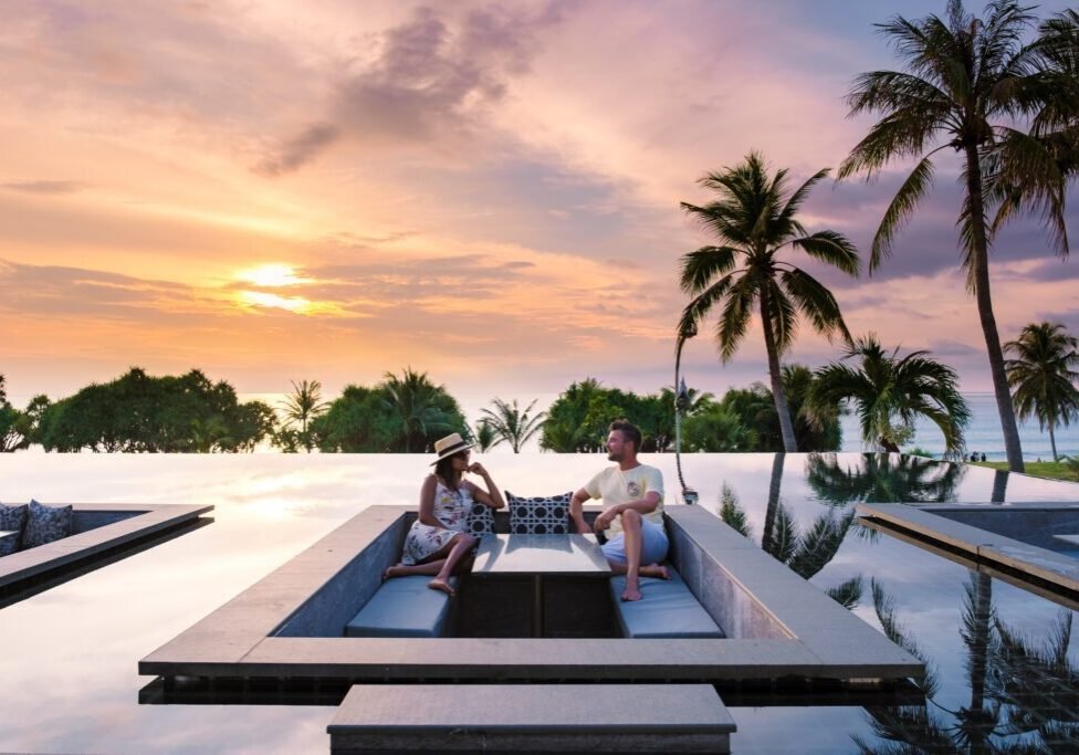 Couple,Watching,The,Sunset,In,An,Infinity,Pool,On,A